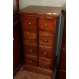 A modern hardwood eight drawer chest with metal knobs