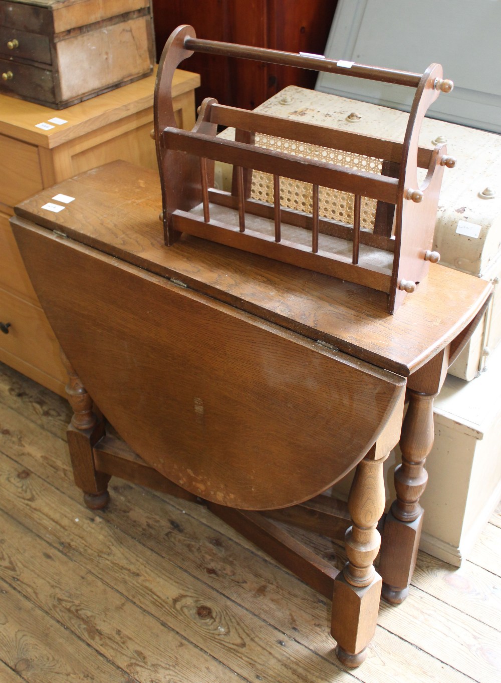 A flap leaf oval gate leg table and magazine rack