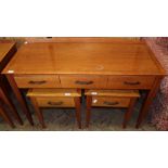 A modern three drawer writing desk and a pair of bedside tables with single drawers