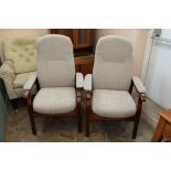 A pair of as new beige upholstered upright armchairs with wooden frames