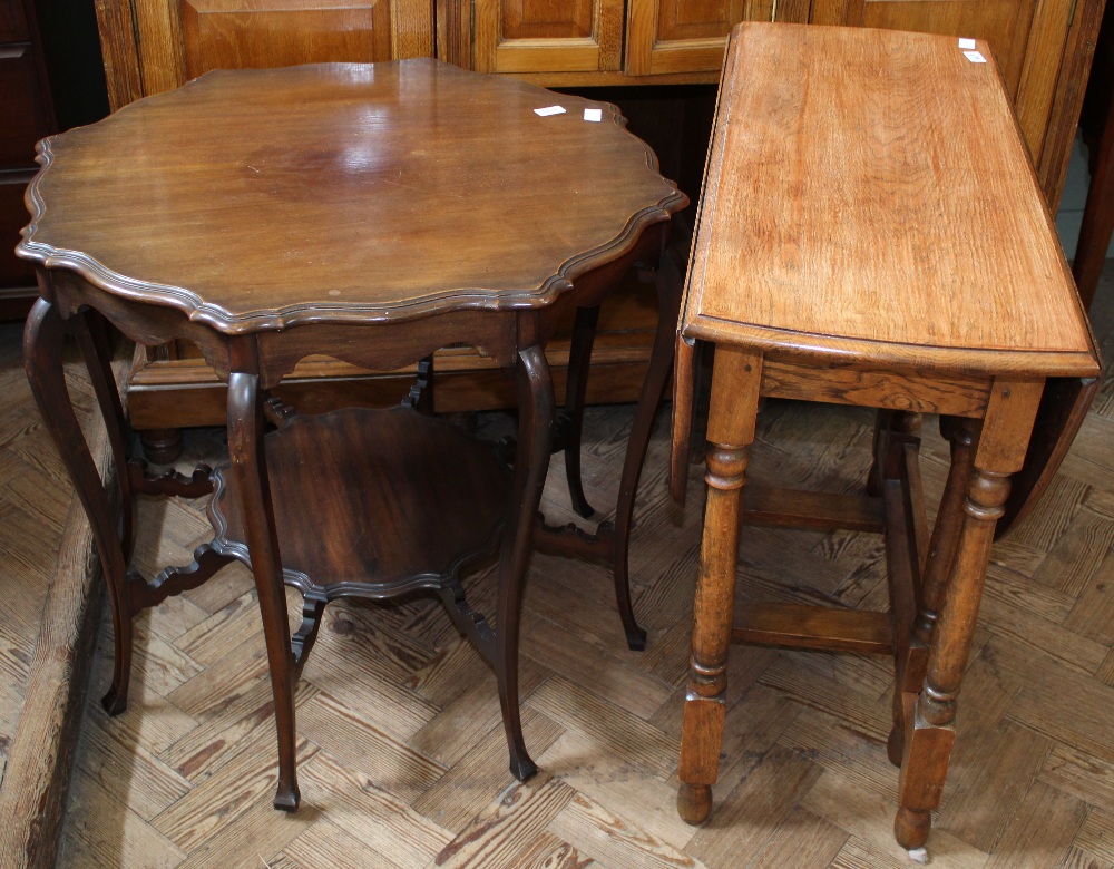 An mahogany reproduction shaped top occasional table with under tier and oak drop leaf table