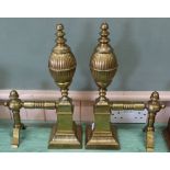 An impressive pair of large 19th Century brass fire dogs with fluted decoration,