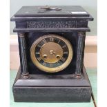 A black slate striking mantel clock
