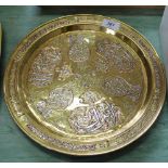 A circular Middle Eastern damascened brass tray