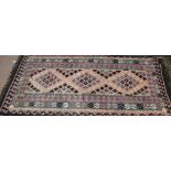 A pink ground flat weave rug,