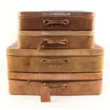 A set of six graduated leather suitcases