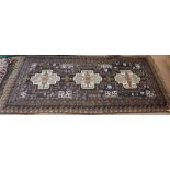 A Persian blue ground rug with central medallions,