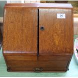 An Edwardian oak stationery box with inkwell and calendar