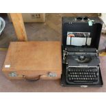 A small leather suitcase, black Underwood typewriter,