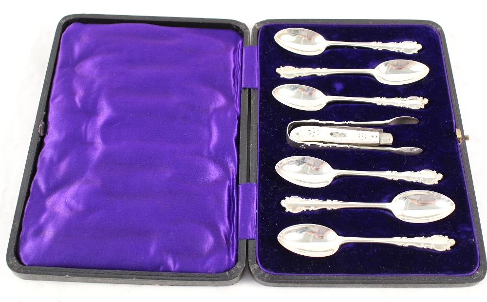 A cased set of silver spoons and tongs plus a silver and mother of pearl fruit knife