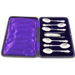 A cased set of silver spoons and tongs plus a silver and mother of pearl fruit knife