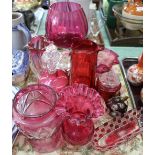 A cranberry glass bell plus other cranberry and red glass