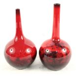 A pair of Royal Doulton flambe narrow neck rural scene vases