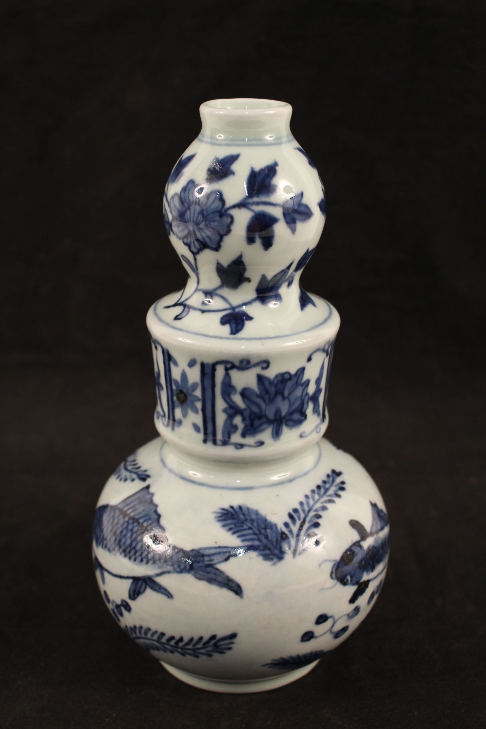 A Chinese blue and white globular and shaped neck vase with carp and floral decoration