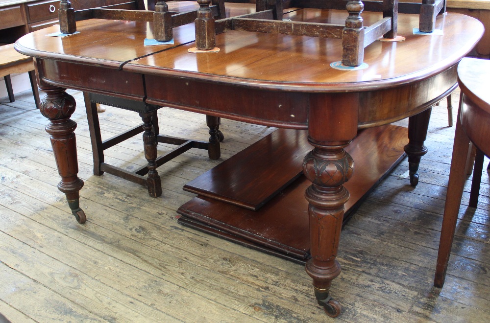 A Victorian mahogany extending dining table with two extra leaves