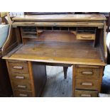 A 1920's oak roll top desk with eight drawers and locking tambour,