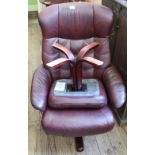 A maroon leatherette Stressless style swivel chair with matching footstool