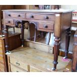 A Victorian mahogany four drawer writing table on porcelain castors