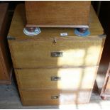 An oak campaign style chest with three drawers and slide