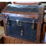 A vintage dome topped leather and canvas travelling trunk