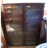 An Edwardian dressing table with four drawers and a glazed cupboard bookcase