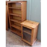 A large modern pine bookcase and a cabinet with glazed door