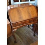 A 1920's lady's writing desk with fitted interior on cabriole legs