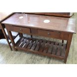 A reproduction two drawer pine serving table with under tier