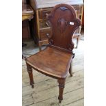 An early Victorian mahogany hard seat hall chair on turned and sabre legs