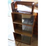 A glazed bookcase with sliding doors and two oak shelves