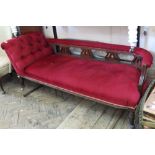 A Victorian chaise longue with carved harp design back and red velvet upholstery