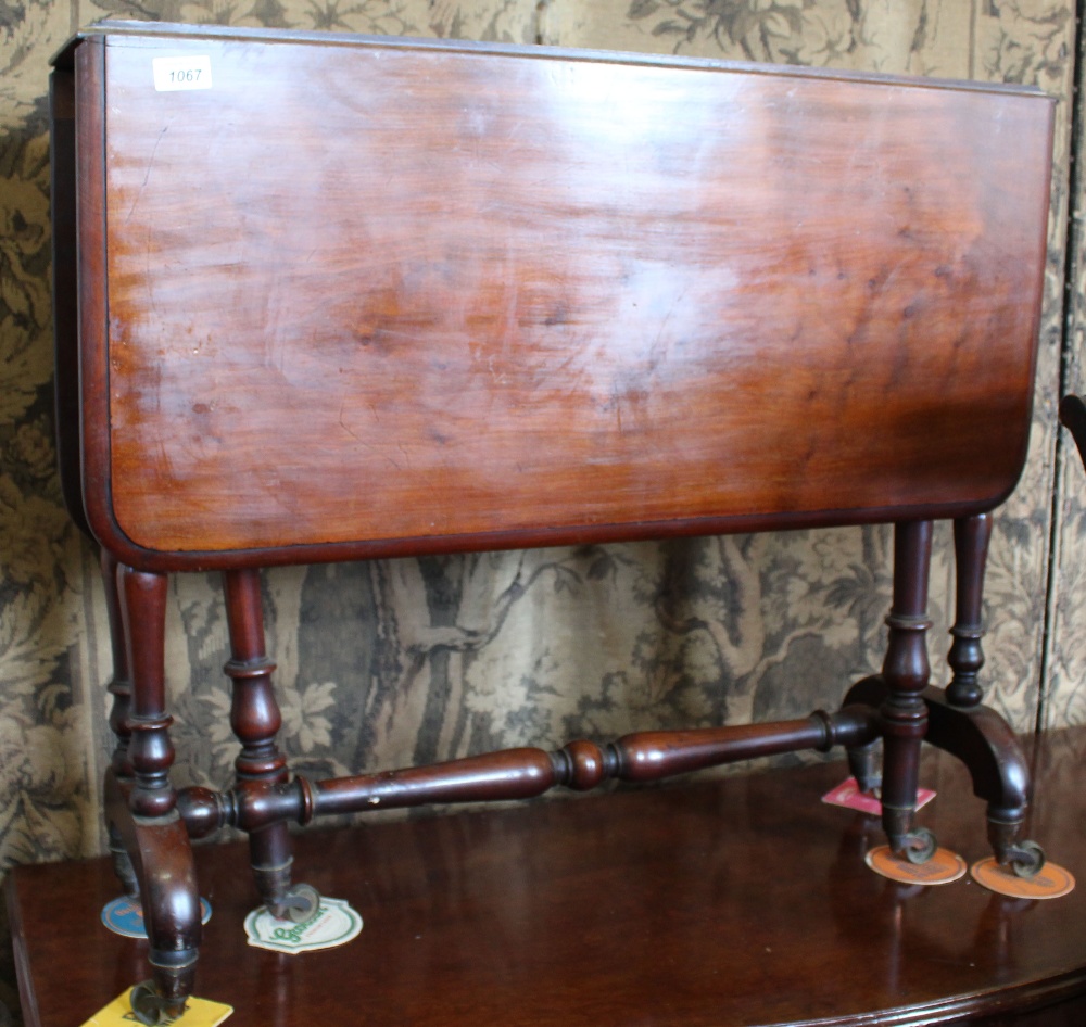A Victorian mahogany Sutherland table with turned legs