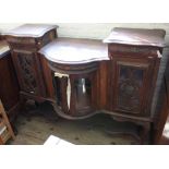 A carved and glazed bow fronted sideboard two drawers and three cupboards (as found)