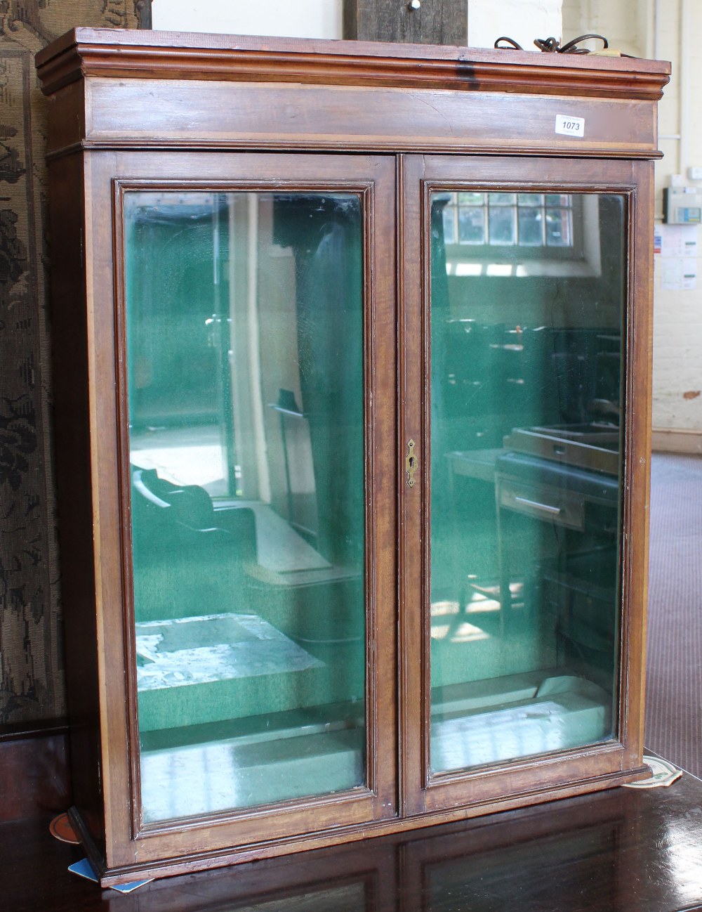 An Edwardian mahogany and pine two door display cabinet