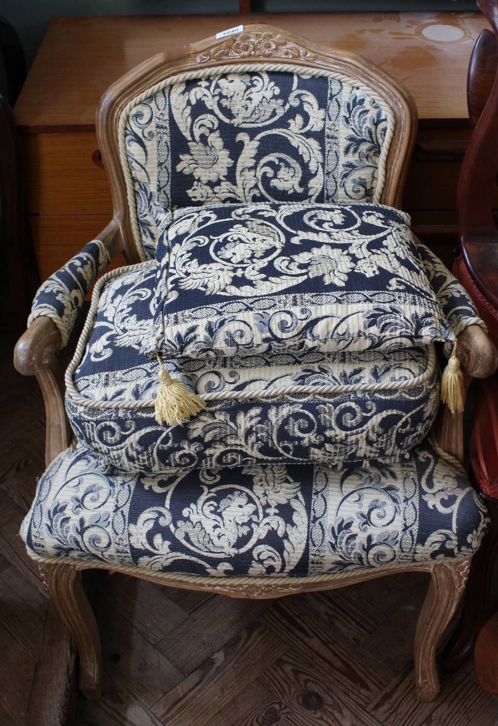 A French oak upholstered armchair,