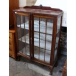 An Edwardian glazed china display cabinet with claw and ball feet