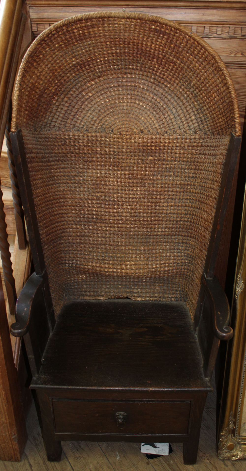 A 1920's Orkney porter's chair with oak frame and sea grass domed back