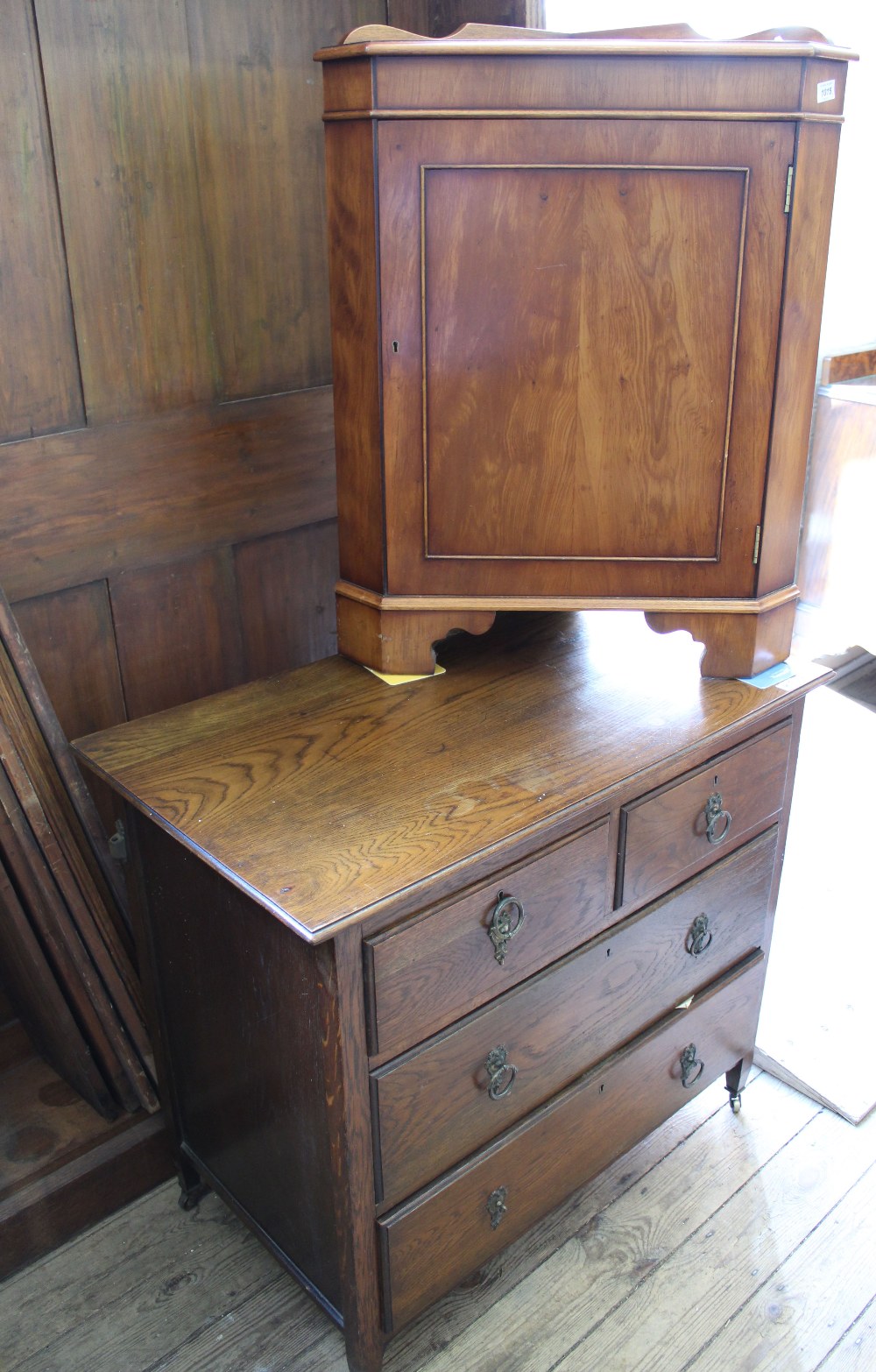 An Edwardian oak four drawer chest and a modern yew corner cupboard