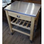 A modern food preparation island, with metal top, single drawer,