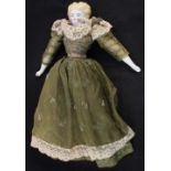 A Victorian porcelain head doll with lace trimmed silk dress and porcelain legs and arms