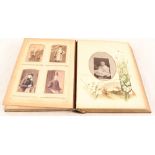 A Victorian photo album and photos including boy with penny farthing,