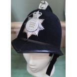 A Police helmet bearing Essex Police insignia plate