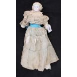 A Victorian porcelain head doll with silk and lace dress (missing hands and feet)
