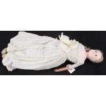 A Victorian wax head doll with linen dress and leather arms and shoes (one missing arm)
