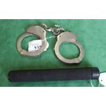 A pair of British Police handcuffs by Hiatt with key,