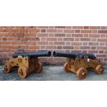 A pair of decorative cannons, the handmade bespoke wooden carriages supporting barrels (34" long),