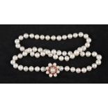 A pearl necklace with large 9ct gold clasp set with pearls and rubies in flower shape