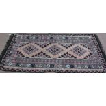 A pink ground flat weave rug,