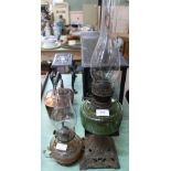 A green glass iron base oil lamp plus one other