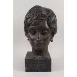A signed bronze head of a woman,